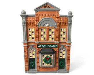 Department 56 Original Snow Village Apothecary #5076-8 ceramic Christmas village building
Condition: Good
Painted ceramic miniature building styled as an old-fashioned apothecary/pharmacy, with orange-brown brick, gray architectural trim, tall windows, central bay window, wreaths on the lower doors, APOTHECARY sign, and '1884' in the pediment. Likely part of a holiday village display.