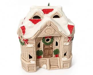 Ceramic Lighted Christmas Village House Holiday Décor
Condition: Good
White ceramic lighted Christmas house with molded snow roof, red roof accents, wreath details, potted plants, and brown front door. Decorative holiday tabletop piece, likely intended as a lighted village house or seasonal accent.