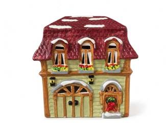 Hand-Painted Ceramic Village House Luminary
Condition: Good
Small decorative ceramic house with a deep red shingled roof, pale green siding, brown trim, arched upper windows, and a holiday-style wreath/floral detail at the front door. The sculpted openings suggest it may function as a candle holder or luminary. No visible damage is apparent from the image, though the underside is not shown.