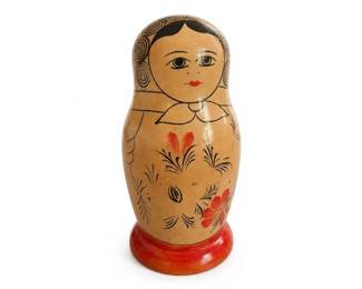 Hand-Painted Russian Matryoshka Nesting Doll Folk-Art Figure
Condition: Good
Single hand-painted wooden nesting doll with a tan body, black-outlined face and hair, floral decoration in red/black, and a red pedestal base. Decorative collectible rather than a functional item.