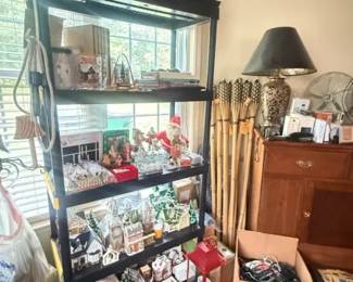 Black metal 5-tier open shelving unit
Condition: Good
Tall black open shelving/display unit with five shelves, used for decor and mixed household storage. Visible wear appears light to moderate from use and handling; no obvious structural break is visible in the image. The holiday village and other objects shown are secondary contents, not part of the salable furniture item.