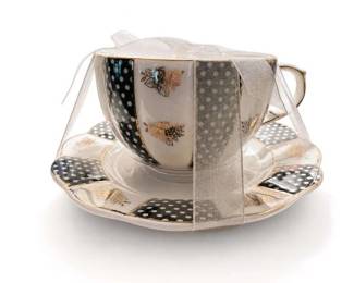 Decorative polka dot butterfly teacup and saucer set
Condition: Good
Single decorative teacup with matching saucer, gold-trimmed, with alternating black, gray, and white polka-dot panels and small butterfly motifs. Presented with a sheer ribbon/bow. Appears to be a collectible/display tea set rather than everyday utilitarian ware.
