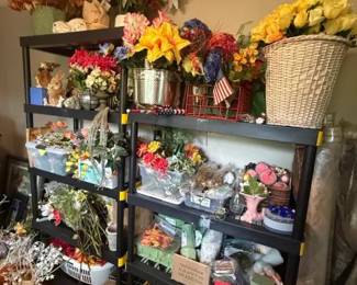 Artificial Silk Flower Assortment Lot
Condition: Good
Large mixed assortment of artificial flowers in multiple colors and container styles, displayed on shelving. Visible components include faux bouquets, stems, basket arrangements, and assorted floral craft/decor items. No single branded product or complete matched set is evident from the photo.
