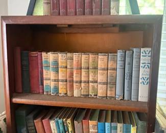 Assorted Vintage Hardcover Books Shelf Lot
Condition: Fair
Mixed shelf lot of approximately 40 vintage/older hardcover books in assorted colors and sizes. Several appear to be decorative or older reference/fiction volumes; condition looks mixed with visible wear to spines and edges. No complete matching set is apparent.