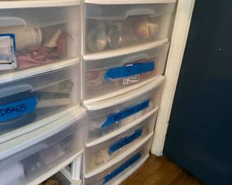Plastic stackable 5-drawer storage organizer cabinet
Condition: Good
White plastic multi-drawer storage cabinet used in a closet for seasonal household items. Visible labels include handwritten tape for categories such as summer/holiday storage, which appear to describe contents rather than the product itself.