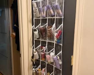 Clear-Pocket Over-the-Door Hanging Toiletry Organizer
Condition: Good
Tall over-the-door hanging organizer with many clear pockets filled with assorted cosmetics, lotions, and travel-size toiletries. Secondary items are contents of the organizer and are not treated as separate salable units in this appraisal.