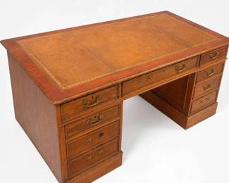 Antique oak partners desk with leather top and brass hardware
Condition: Good
Large traditional partners desk with a rectangular leather-inlaid top, wood veneer or solid wood case, and drawer pedestals on both sides. Brass bail pulls and centered writing drawers suggest an office desk intended for use from either side. Finish shows age-appropriate wear and patina, but no obvious major structural damage is visible from the photo.