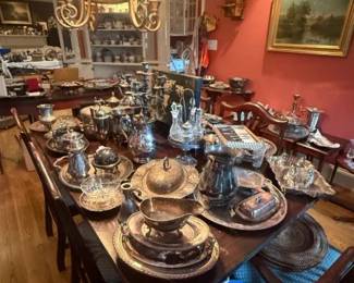 Ornate Silverplate Tea and Coffee Service Mixed Lot with Trays
Condition: Good
Large mixed lot of ornate silverplate serving pieces displayed together on a dining table. Visible items appear to include trays, teapots/coffee pots, creamers, sugar bowls, serving bowls, covered dishes, and assorted small tableware. Condition appears generally presentable from a distance, but exact completeness, plate wear, and any dents or pitting are not verifiable from this image alone.