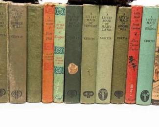 Alice Turner Curtis 'A Little Maid' juvenile book lotCondition: FairAssorted antique/vintage clothbound juvenile novels in the 'A Little Maid' series by Alice Turner Curtis, with visible titles including several state/place-based volumes. Condition shows significant shelf wear, rubbed corners, faded spines, and staining/discoloration on some books.