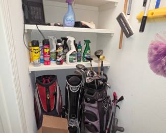 Golf bags and a few clubs