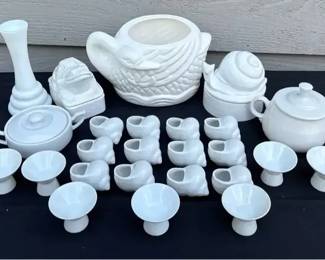 white ceramic or porcelain tableware featuring various animal and shell motifs