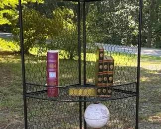 Metal Corner Shelf With Bronze, Toned Statue, A Globe Book Ends A Globe Clock, And An Hourglass