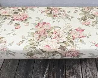 upholstered bench featuring a vintagestyle pink and green floral fabric and small turned wooden fee