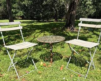 Pair Of Bistro Chairs And Metal Base Accent Table With Flowers And Trees