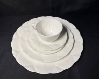 white bone china place setting from the Oceanside pattern featuring an embossed fan seashell design