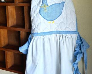Cute Apron. Shelf is not for sale.