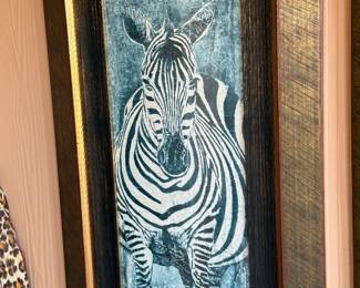 Make a bold statement with this striking contemporary zebra wall art. The artwork features a dramatic portrait of a zebra in a textured combination of blue, gray, black, and white, giving it a modern yet slightly rustic appearance.