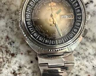 "Orient" Automatic Watch (1970's -80's ) with Serial # F469603-6A P Auto Mechanical Movement w/21jewels Case is Stainless Steel 37-38mm wide, analog display w/day/date aperture and sweep center seconds.B 