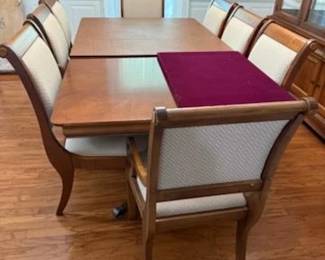 Beautiful Dining Suite of Quality Cherrywood Featuring: Table with 2 Leaves with Gorgeous Double Pedestal Base and Custom Padded Top to protect the already Superb Finish. The Table comes with 8 Matching Chairs  consisting of 6 Side and 2 Captains Chairs This Dining Suite also has a Beautiul Lighted China Display Cupboard Door Shelving below Plus Lovely matching Mirrored Sideboard