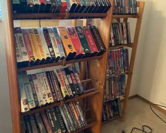 Two Shelves Of VHS Tapes  DVDs With Magnavox Player