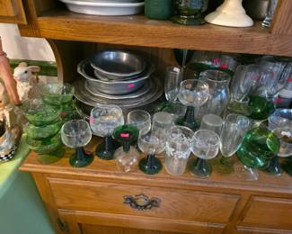 Clear and green glassware. Pewter plates and bowls