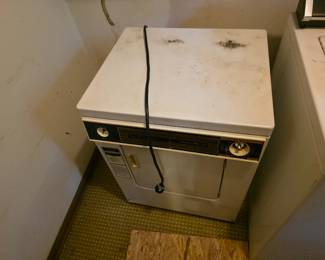 Small electric dryer that is missing its knobs. Still works though.