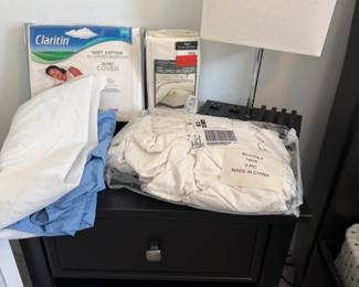 Assorted Twin Bedding and Nightstand Setup