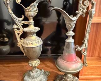 Pair of Ornate Metal Ewers with Cherub and Grape Motifs