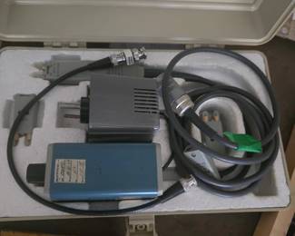 Vintage Electronic Testing Probe Equipment Kit Includes: Oscilloscope/frequency testing probe kit with BNC cables, AC adapter module, blue-cased test interface unit, and fitted hard plastic carrying case. Condition: Sold AS-IS. Displays vintage calibration stickers (1977/1978); untested for functionality. External yellow framing and background surface not included.