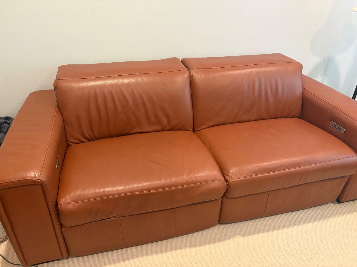 Caramel Italian Leather loveseat (86" W x 42" D) with full recline (64"D),  adjustable headrest - each side operates independantly    