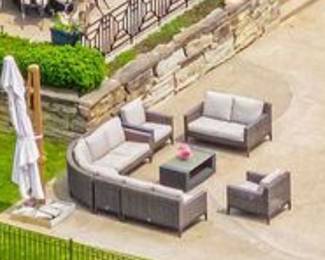 Arial view of the EBEL all season wicker patio furniture:  Curved sectional couch, loveseat, armchairs and "chat" table and full coverage umbrella