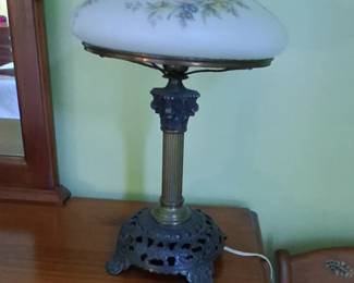 vintage electric hurricane table lamp with a milk glass floral shade and an ornate cast metal base