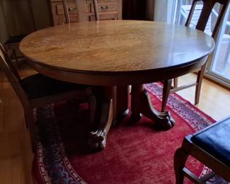 Antique oak clawfoot table with six leaves and six chairs