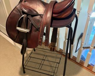 J101 - $500. Stubben Roxane Saddle with Stand. 17.5" seat. 31 cm tree. Serial # 2949956. Made in Switzerland. Light cracking and some discoloration on the seat. Includes 54" leather girth, Lami-Cell gel saddle pad & Metal Rack.