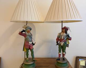 J115 - $175. Pair of Musketeer Cast Iron Lamps. Heavy! Shades are in good condition. Measures 35" Tall.