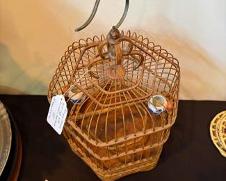 J110 - $60. Antique Chinese Bird Cage with Porcelain Seed and Water Bowls. Measures 10" Hex x 16" Tall.