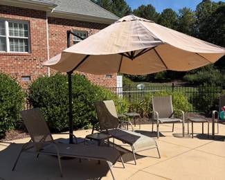 J69 - $100. Adjustable Patio Umbrella & Stand. Umbrella has some sun fading but otherwise in good condition.