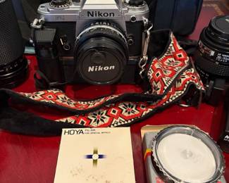 J58 - $120. Nikkon FG 35mm SLR Film Camera. Lens and Accessory Lot. Camera is untested.