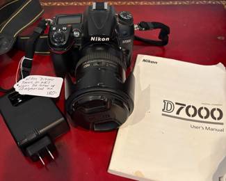 J56 - $180. Nikon D7000 Camera. Alikon DX SMW VR ED Aspherical 72 Lense. Powers on and looks to be in working order.