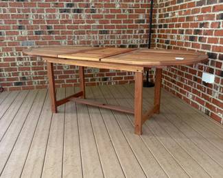 J36 - $400. Teak Patio Table. Measures 63" long x 35.5" wide + 19.5" butterfly leaf. Overall very good condition - has been used on a covered, screened in porch.