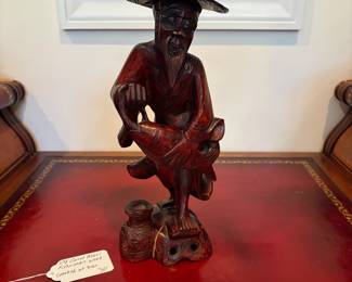 J28 - $30. Vintage Asian Fisherman Carved Red Wood. Cracked at the base.