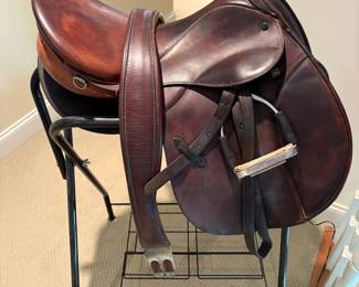 J101 - $500. Stubben Roxane Saddle with Stand. 17.5" seat. 31 cm tree. Serial # 2949956. Made in Switzerland. Light cracking and some discoloration on the seat. Includes 54" leather girth, Lami-Cell gel saddle pad & Metal Rack.