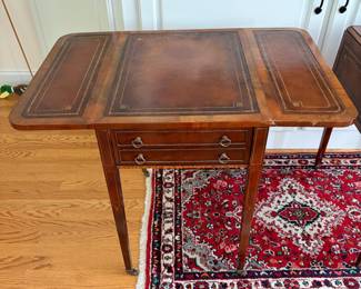 J159 - $150. Pair Of Vintage Drop-Leaf Side Tables with Leather Tops and Brass Wheels. Measures 43" W x 17" W x 27.25" Tall. Each Leaf measures 8.5" W.