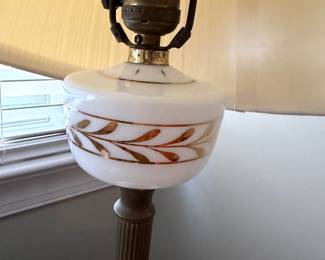 J140 - $50. Marble Base Milk Glass with Gold Leaf Design Lamp with an Equestrian Finial. Measures 19” Tall.