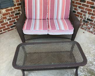 J162 - $95. Brown Resin Wicker Patio Love Seat and Table Set. In good condition with Allen and Roth Cushions that are weathered. . Loveseat Measures 50" W x 33" D x 34.5" Tall. Table Measures 42.5" W x 21.5" D x 16.5" Tall.