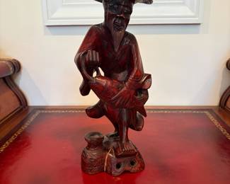 J28 - $30. Vintage Asian Fisherman Carved Red Wood. Cracked at the base.