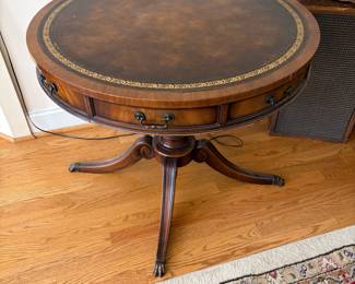 J161 - $95. Vintage Duncan Phyfe Style Drum Table with A Leather Top and Brass Paw Feet. Measures 32" Diameter x 27" Tall.