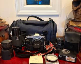 J58 - $120. Nikkon FG 35mm SLR Film Camera. Lens and Accessory Lot. Camera is untested.