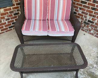J162 - $95. Brown Resin Wicker Patio Love Seat and Table Set. In good condition with Allen and Roth Cushions that are weathered. . Loveseat Measures 50" W x 33" D x 34.5" Tall. Table Measures 42.5" W x 21.5" D x 16.5" Tall.