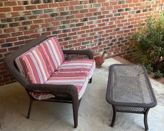 J162 - $95. Brown Resin Wicker Patio Love Seat and Table Set. In good condition with Allen and Roth Cushions that are weathered. . Loveseat Measures 50" W x 33" D x 34.5" Tall. Table Measures 42.5" W x 21.5" D x 16.5" Tall.